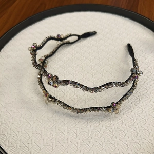 Detail of double-layer wave headband with sparkling crystals and beaded flower decor