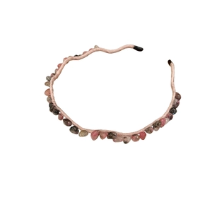 Elegant pink headband decorated with polished irregular stones and beads on white background