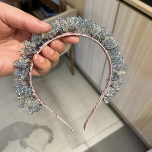 Detailed close-up of handmade blue crystal beaded headband with satin wrapped frame