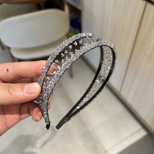Detail of handmade crystal headband with mesh-wrapped black wire and transparent beads