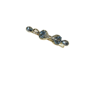 Luxurious gold crystal bow hair clip with dark blue gemstones on white background