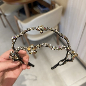 Macro detail of double-layer crystal headband with champagne beads in hand