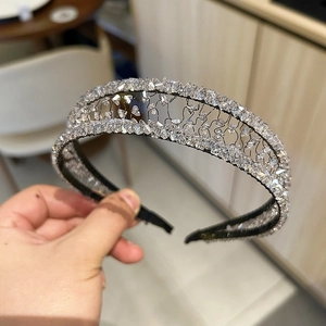 Detail of wide crystal headband with handmade wire floral lace design and clear stones