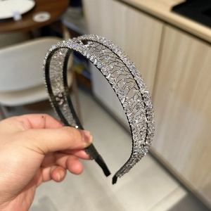 Detail of handmade hollow crystal headband with woven metal wire and rhinestone accents