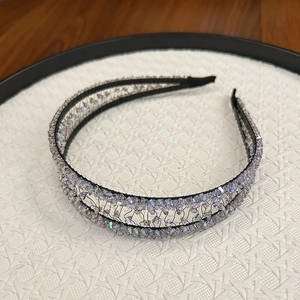 Macro detail of handmade crystal headband with intricate hollow weaving and lilac beads