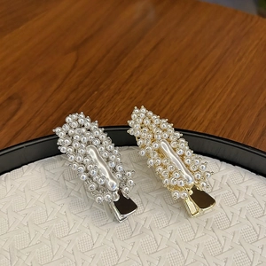 Detailed view of handmade crystal pearl hair clips in gold and silver finishes