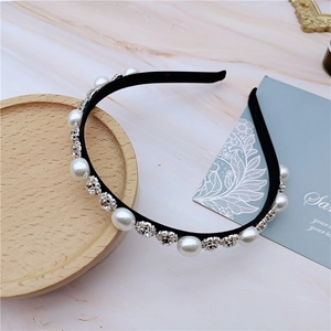 Detailed view of elegant black headband with white pearls and sparkling plum blossom rhinestones