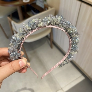 Detail of pink satin headband with hand-wrapped light blue crystals and beads