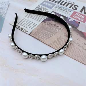 Detail of elegant headband with alternating white faux pearls and sparkling rhinestones