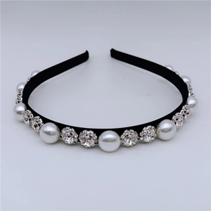 Close-up of elegant black headband featuring alternating white pearls and sparkling rhinestones