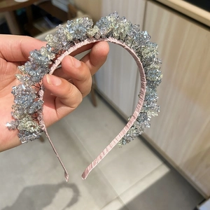 Detailed view of handmade pink crystal headband with sparkling blue beaded tassels