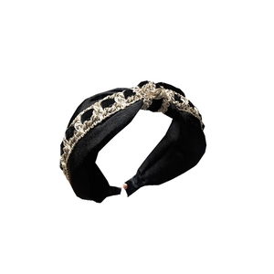 Elegant black velvet headband with a braided gold chain featuring a luxury interlocking design