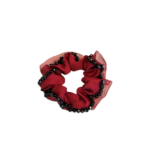 Burgundy satin scrunchie with hand-stitched black crystal beads on a white background