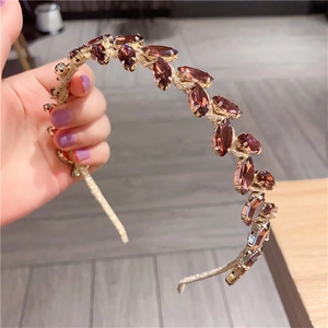 Detailed macro view of baroque headband featuring marquise cut brown crystals in metal setting