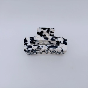 Close-up of large marble acetate hair claw clip with strong metal spring and teeth