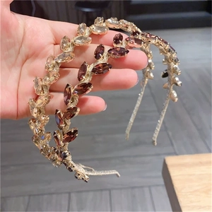 Detail of luxury Baroque leaf hairbands with sparkling champagne and brown rhinestones