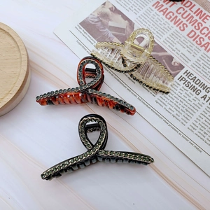 Dettaglio di fermagli per capelli con strass e acrilico in vari design alla moda