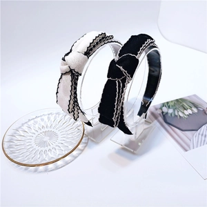 Detail of black and white knitted bow headbands with wavy contrast stitching