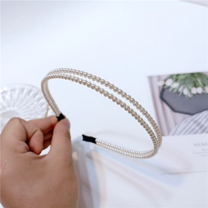 Detailed view of the double-row pearl headband with comfortable black fabric padded ends