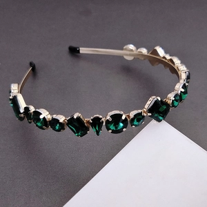 Luxurious gold-plated headband with emerald green crystals in various geometric shapes