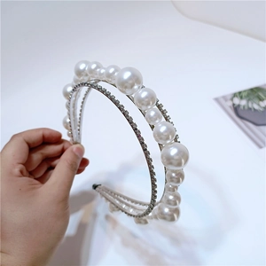 Detail view of double-layer headband featuring white pearls and shimmering rhinestones