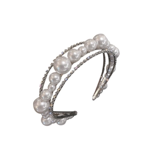 Elegant triple-layered headband featuring rows of sparkling rhinestones and white pearls