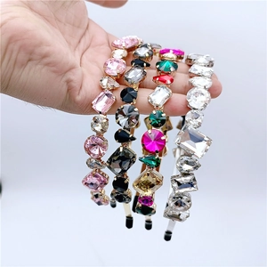 Detailed macro view of four luxury rhinestone headbands with colorful crystal inlays