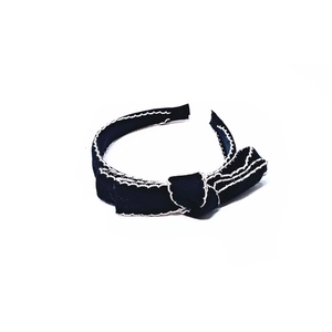Elegant black fabric headband with white wavy stitching and side bow knot detail