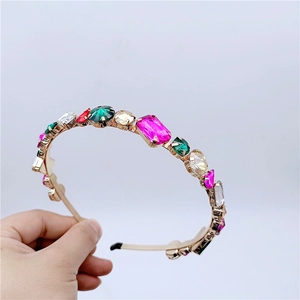 Close-up of luxury crystal headband featuring colorful gemstones in metal claw settings