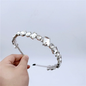 Close-up of luxury silver-tone headband with multi-shape sparkling crystals and gems