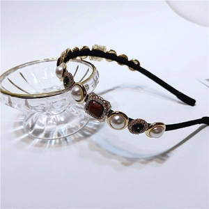 Detail of baroque pearl headband with vintage amber gems and crystals in golden frames