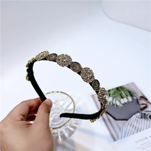 Detail of vintage headband with clockwork metal discs and sparkling rhinestones
