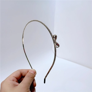 Detail of silver thin headband with pavé rhinestones and double teardrop crystals