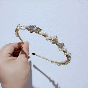 Baroque style gold headband with pearls and rhinestones featuring butterfly and flower motifs