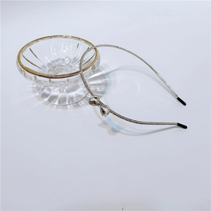 Detailed view of silver metal headband featuring rhinestone bow and black end tips
