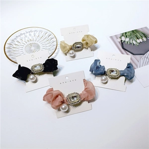 Elegant satin rhinestone scrunchies with pearl pendants in black, pink, and blue shades