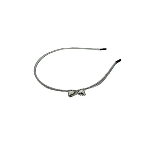 Elegant silver metal headband with crystal heart bow design and glitter finish