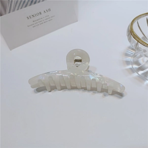 Detail view of large pearl white acetate hair claw clip with shimmering mermaid finish