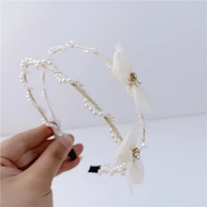 Elegant wavy headband set featuring mesh bows, faux pearls, and sparkling crystals for women