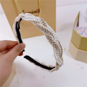 Elegante geweven parelhoofdband met gouddraad en handgemaakt label op geschenkdoos