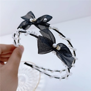 Detail of double-layer headband with black mesh bows and sparkling crystal pearls