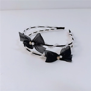 Detailed close-up of mesh bow headbands with faux pearls and sparkling crystal beads
