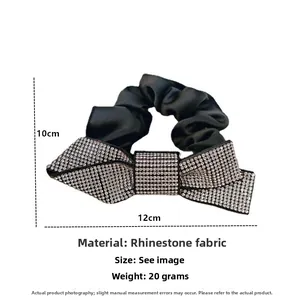 Detail of black silk scrunchie with sparkling rhinestone bow, size 12cm by 10cm