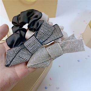 Elegant satin scrunchie set with sparkling rhinestone bow tie in black and apricot