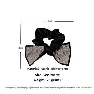 Detail of black satin bow hair tie with silver rhinestones measuring 14cm by 12cm