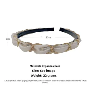 Detail view of organza and golden chain headband with dimensions 2cm width and 13cm diameter