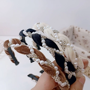 Detail of velvet braided headbands with artificial pearls and rhinestones in three colors
