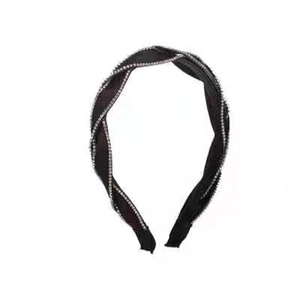 Elegant black twist headband featuring a minimalist design with sparkling rhinestone trim
