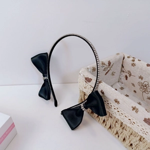 Elegant black headband with sparkling rhinestones and satin bows for daily wear