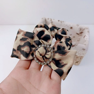 Silk leopard print hair scrunchie with large bow and rhinestone circle buckle for women